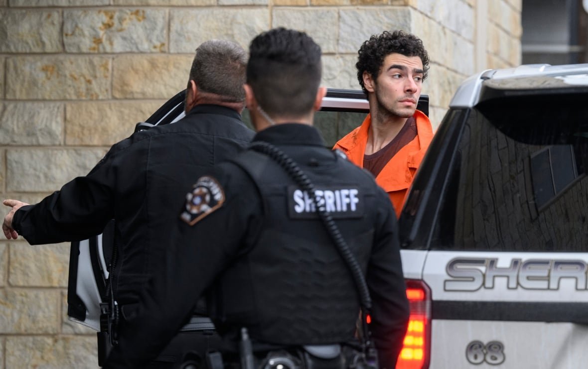 Suspected shooter Luigi Mangione is led into the Blair County Courthouse for an extradition hearing.