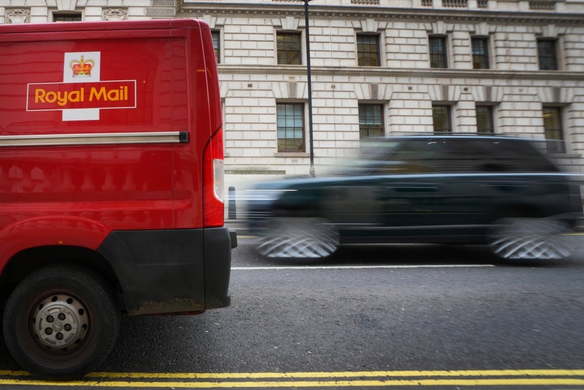 A car overtakes a Royal Mail delivery van, in Westminster in London, Thursday, Jan. 25, 2024. Royal Mail could save millions by moving to three-day-a-week service. Ofcom are 'not credible' in the debate around post office reforms, CWU general secretary Dave Ward said on Wednesday in response to Ofcom proposals which could see Royal Mail delivery services cut down to as little as three days a week. (AP Photo/Kirsty Wigglesworth)