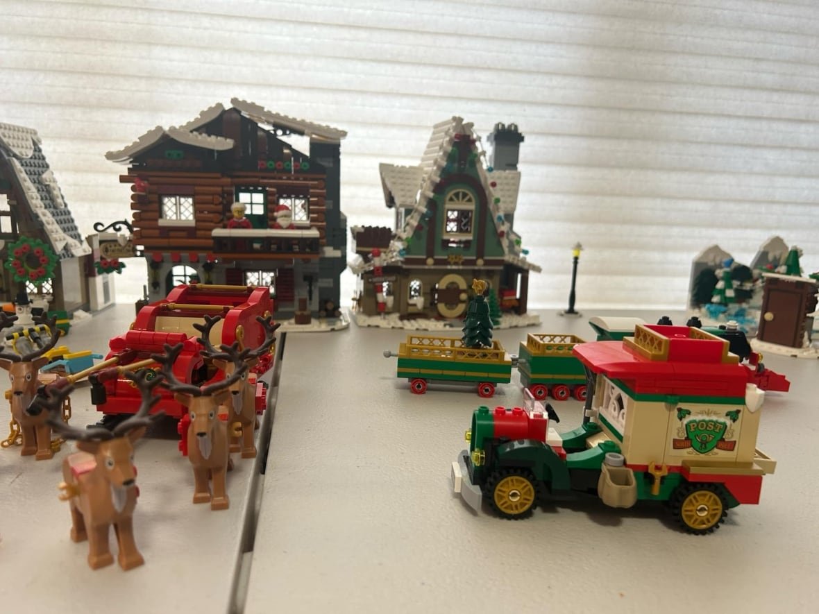 Lego set up on a table, including reindeer and Santa's sleigh.