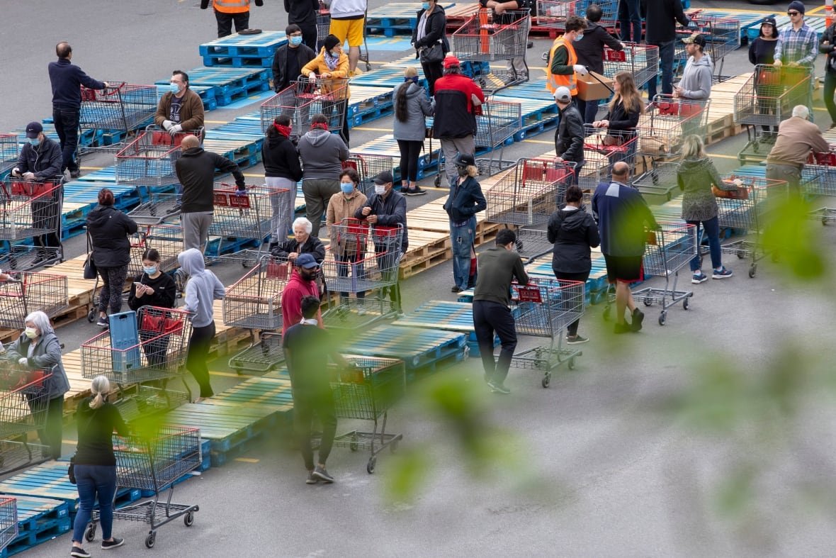 Customers wait in a line-up outside to get inside Costco Wholesale store in Burnaby.