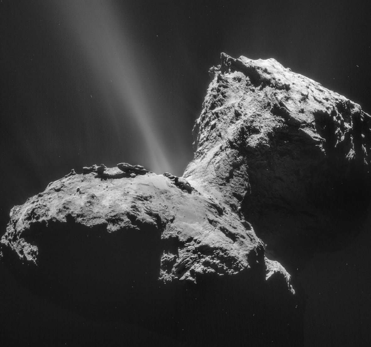 A rocky dumbell-looking comet is shown against the black backdrop of space. 